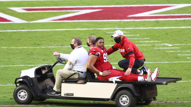 Arizona Cardinals defensive tackle Corey Peters (98) reacts as he is charted off the field after suffering an injury against the Buffalo Bills at State Farm Stadium.